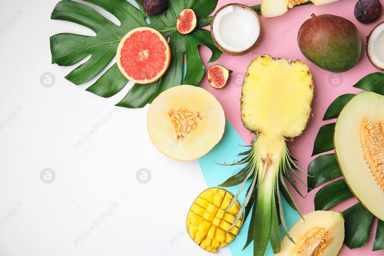 Photo of Flat lay composition with melon, other fruits and space for text on color background