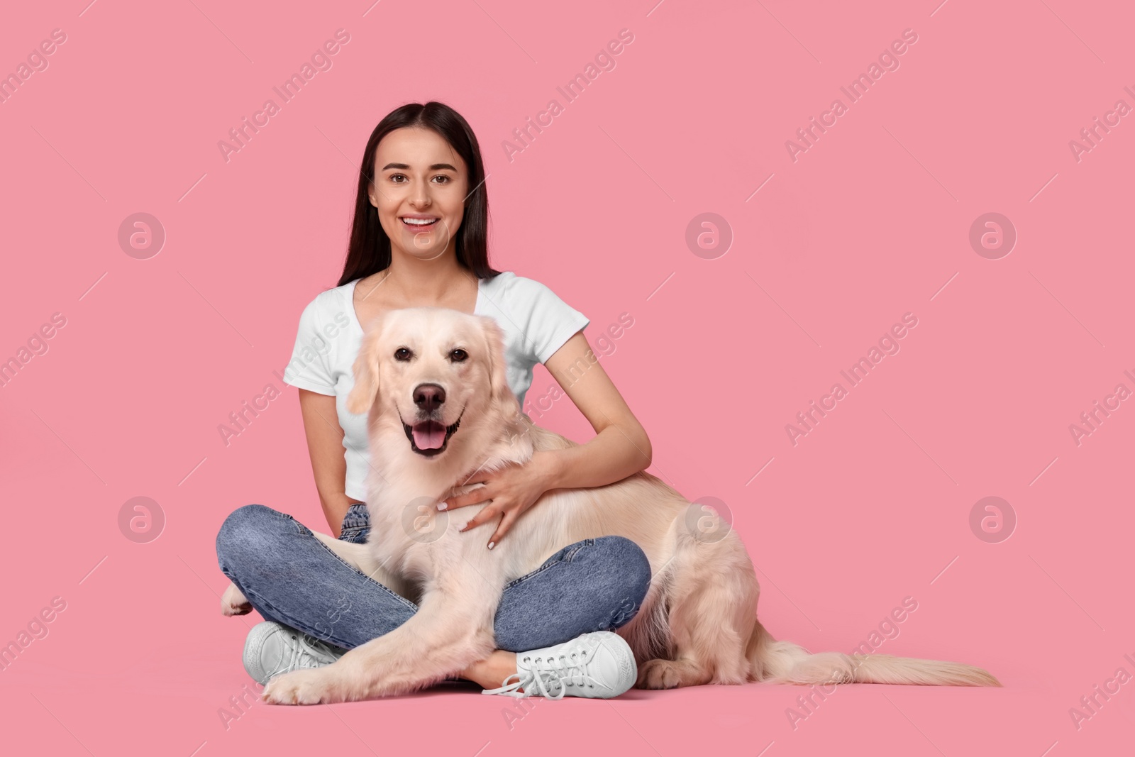 Photo of Happy woman with cute Labrador Retriever dog on pink background, space for text. Adorable pet