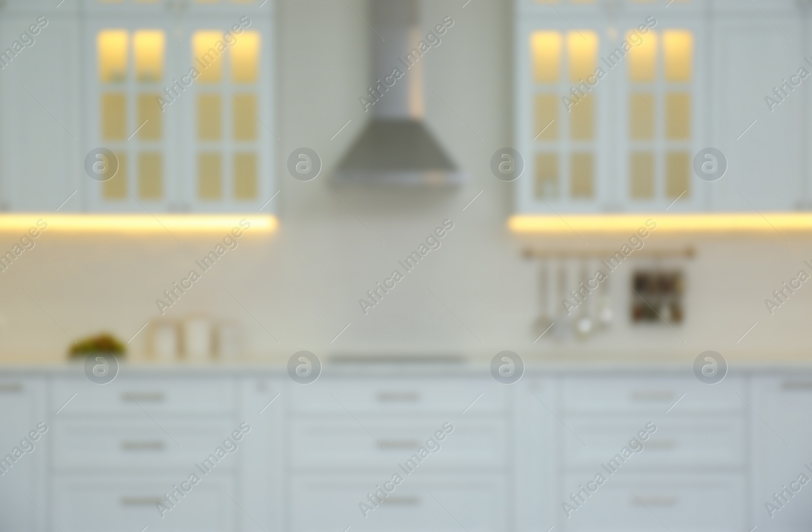 Photo of Blurred view of modern kitchen interior with stylish furniture