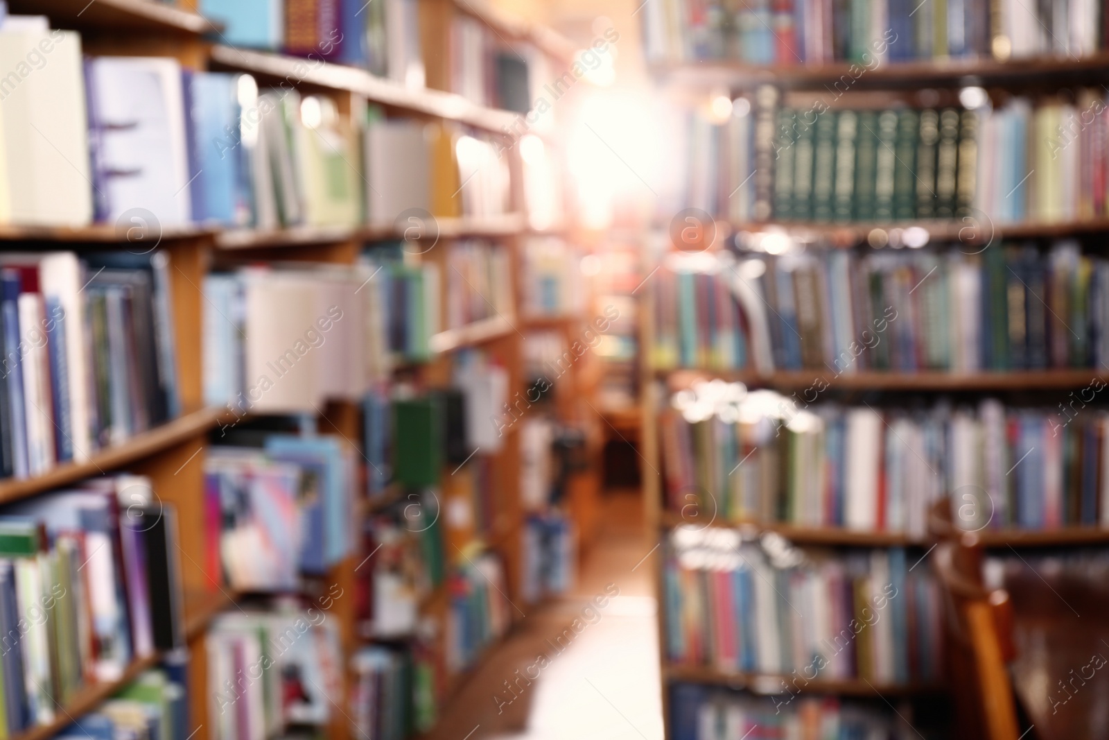 Photo of Blurred view of different books on shelves in library