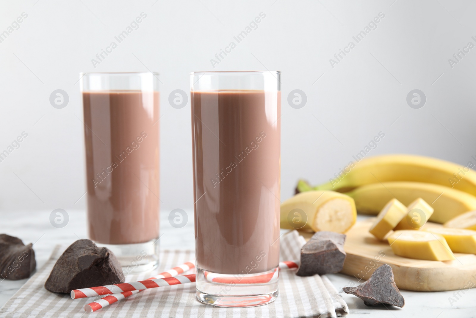 Photo of Fresh yummy chocolate milk on white table