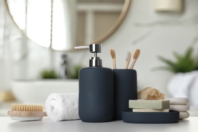 Image of Bath accessories. Different personal care products on white table in bathroom