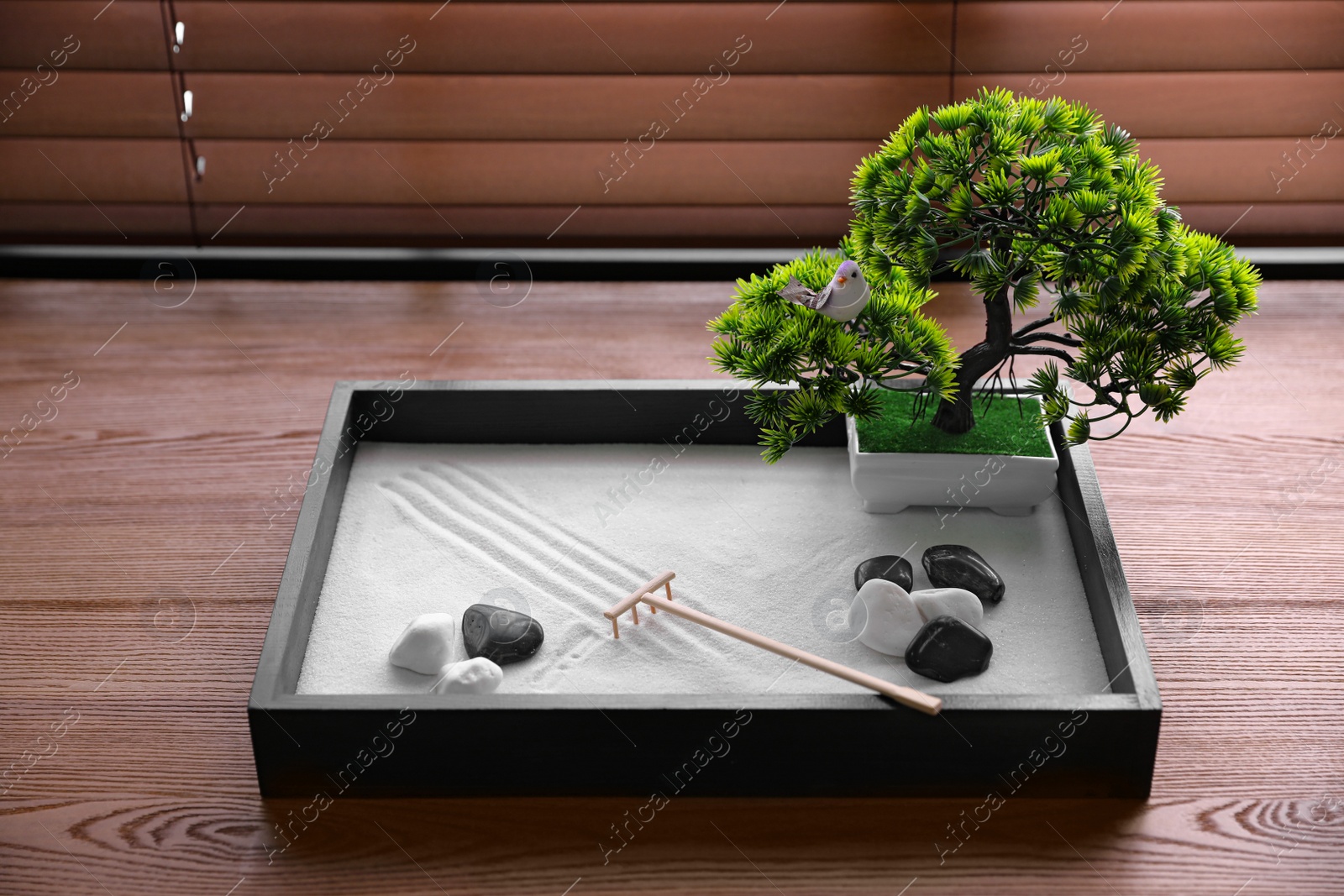 Photo of Beautiful miniature zen garden on wooden table