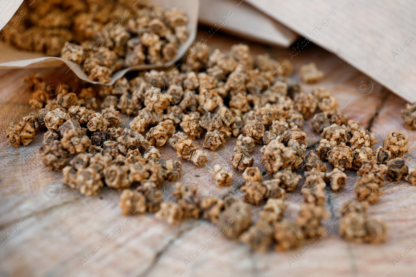 Photo of Paper bags with beet seeds on wooden background, closeup. Vegetable planting