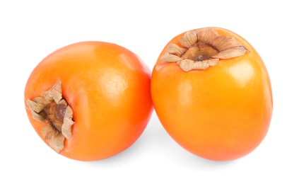 Photo of Delicious ripe juicy persimmons isolated on white