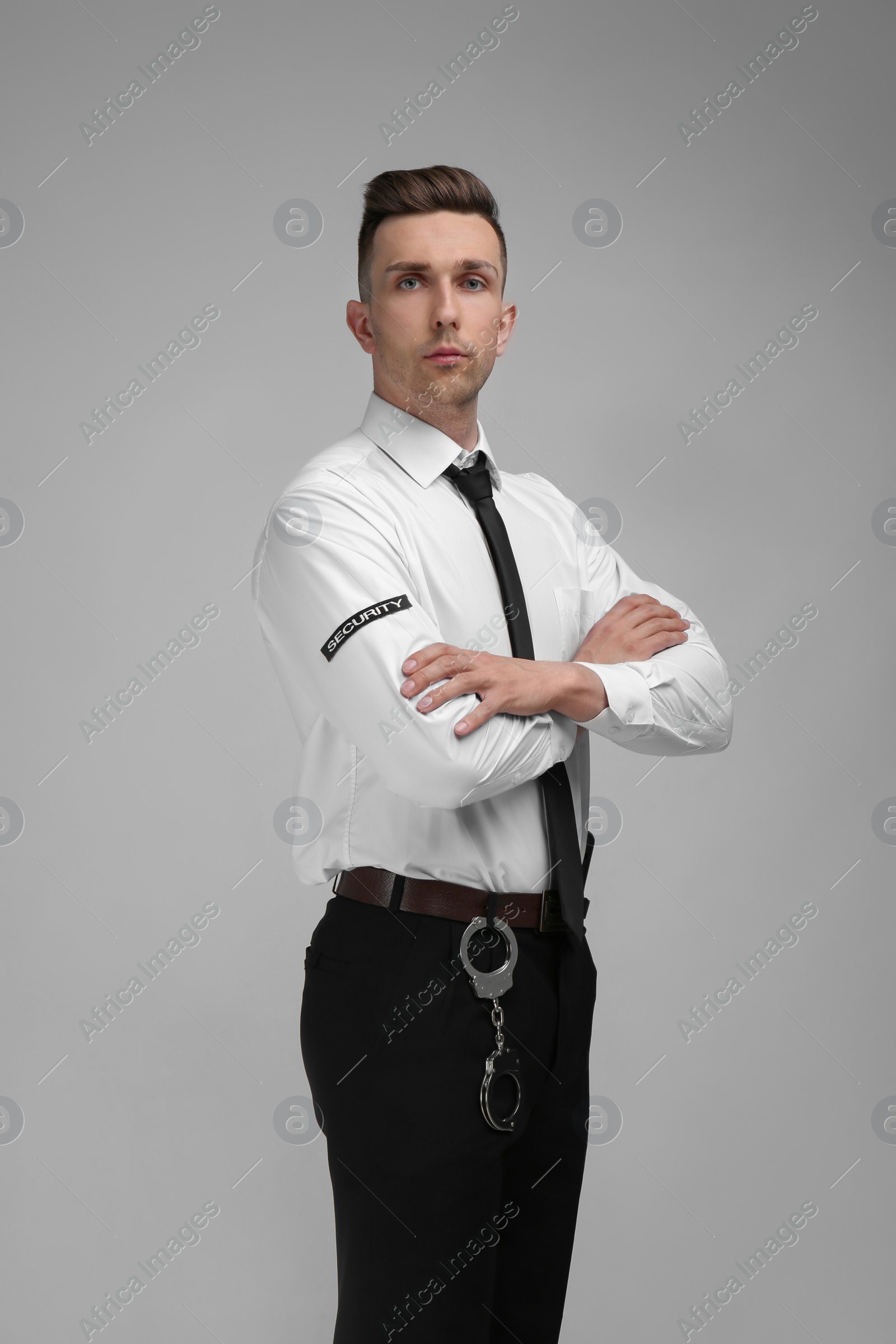 Photo of Male security guard in uniform on color background