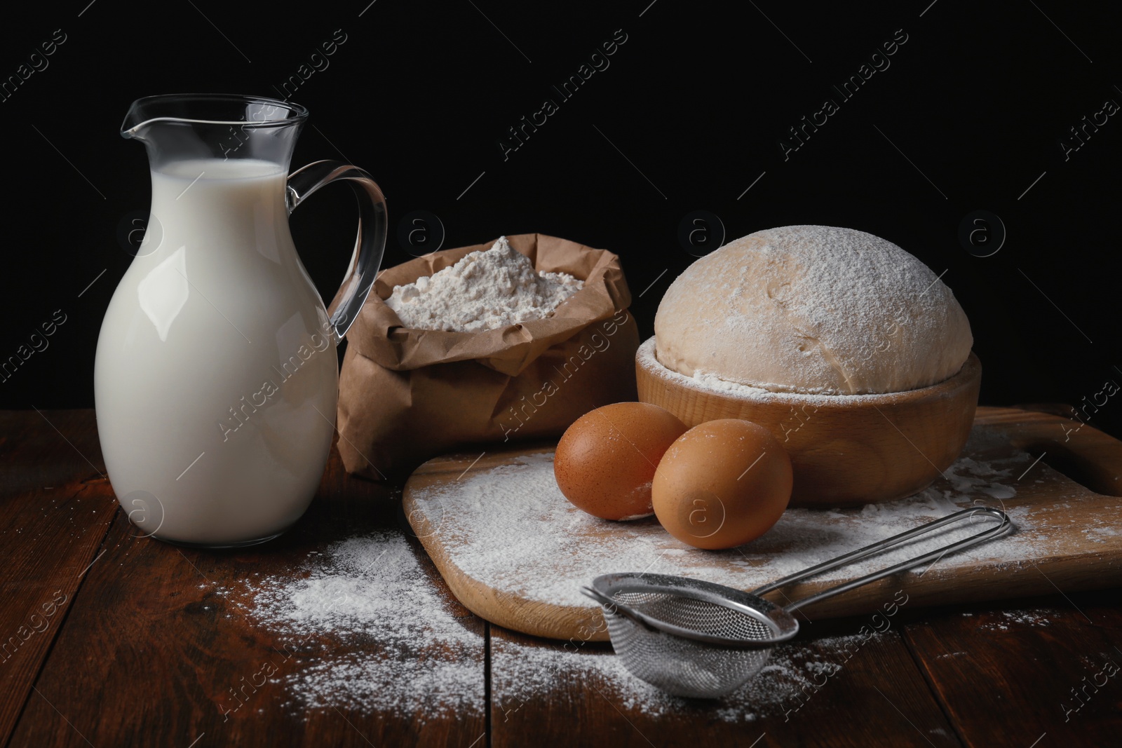 Photo of Raw eggs and other ingredients on wooden table. Baking pie