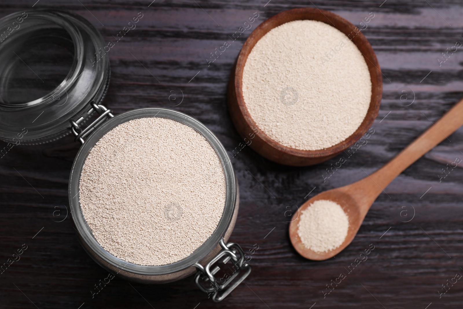 Photo of Active dry yeast on wooden table, flat lay