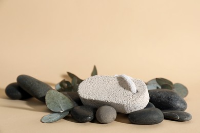 Photo of Pumice and spa stones on beige background, space for text