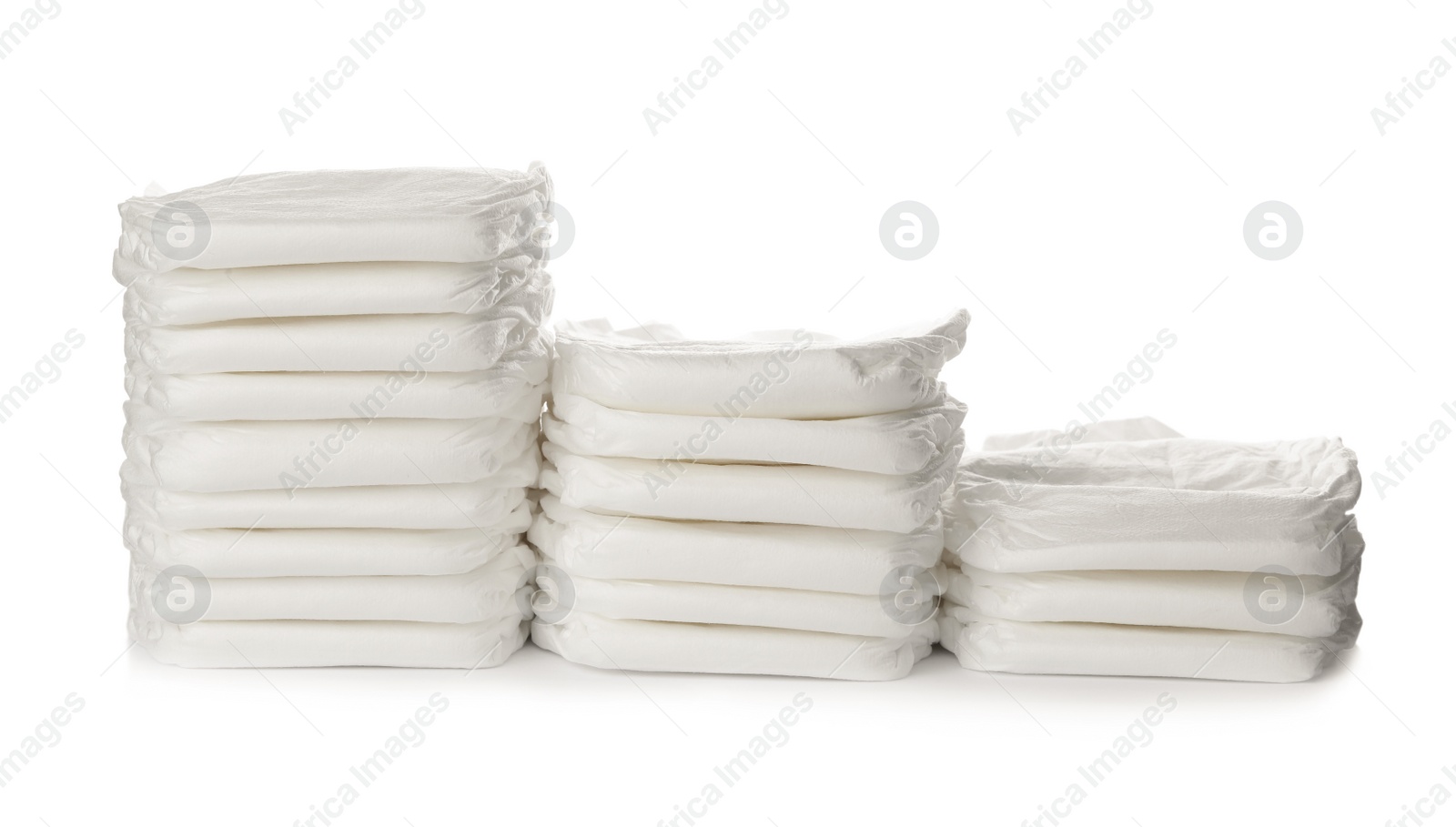 Photo of Stacks of baby diapers isolated on white