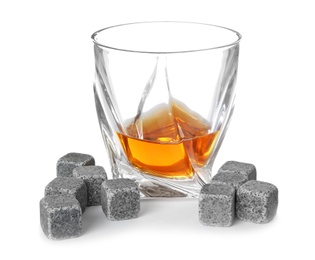 Glass with liquor and whiskey stones on white background