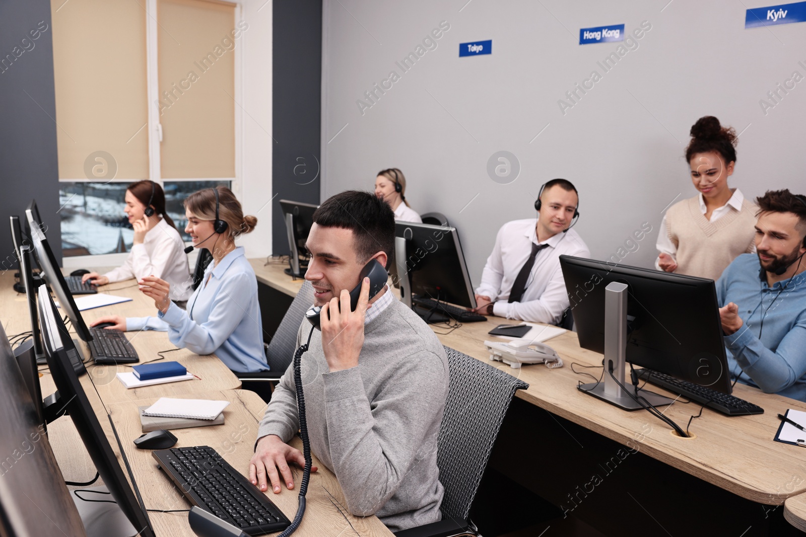 Photo of Call center operators working in modern office