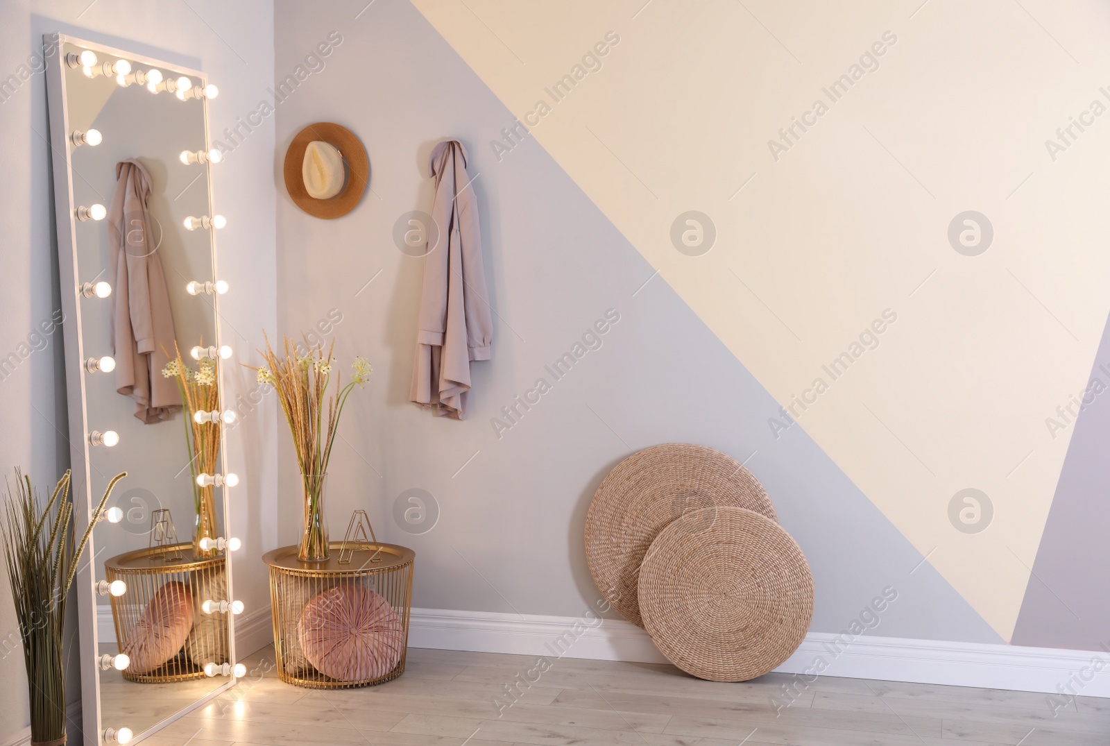 Image of Full length dressing mirror with lamps in stylish room interior