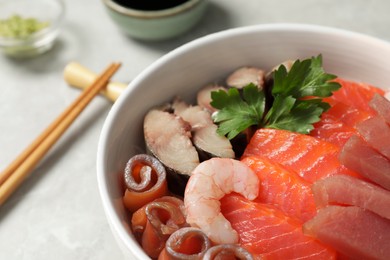 Photo of Delicious mackerel, shrimps, salmon and tuna served with parsley on grey table, closeup. Tasty sashimi dish