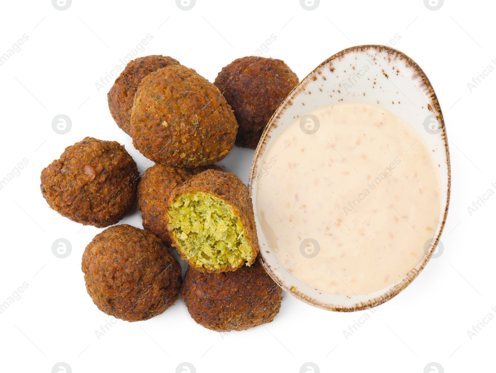 Photo of Delicious falafel balls and sauce isolated on white, top view