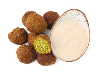 Photo of Delicious falafel balls and sauce isolated on white, top view