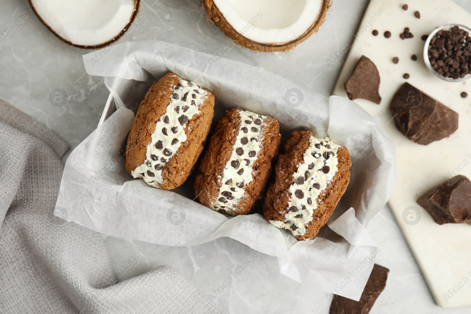 Photo of Sweet delicious ice cream cookie sandwiches served on table, flat lay