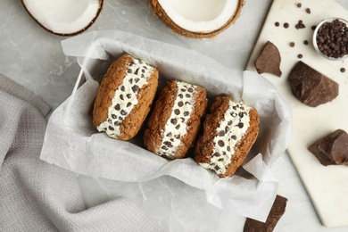 Photo of Sweet delicious ice cream cookie sandwiches served on table, flat lay