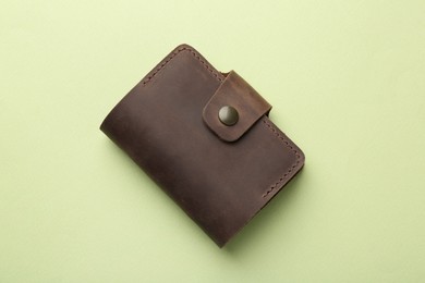 Photo of Leather card holder on light green background, top view