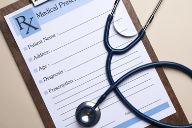 Photo of Clipboard with medical prescription form and stethoscope on beige background, flat lay