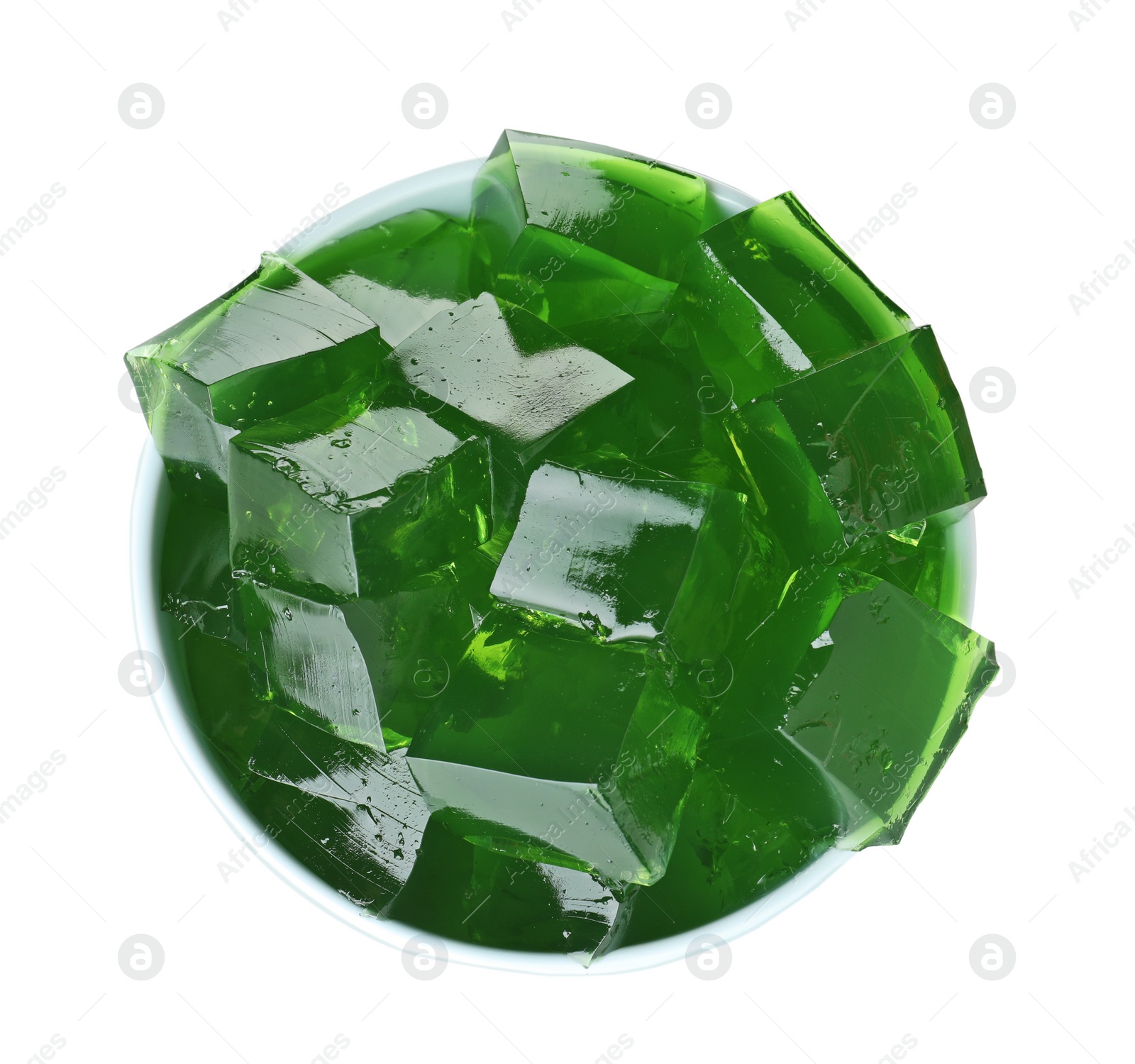 Photo of Bowl with green jelly cubes on white background, top view