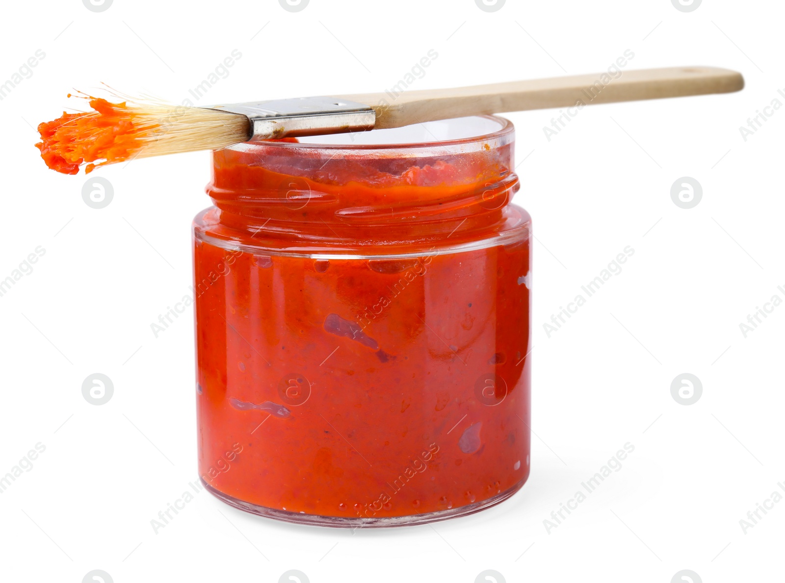 Photo of Fresh marinade in jar and basting brush isolated on white