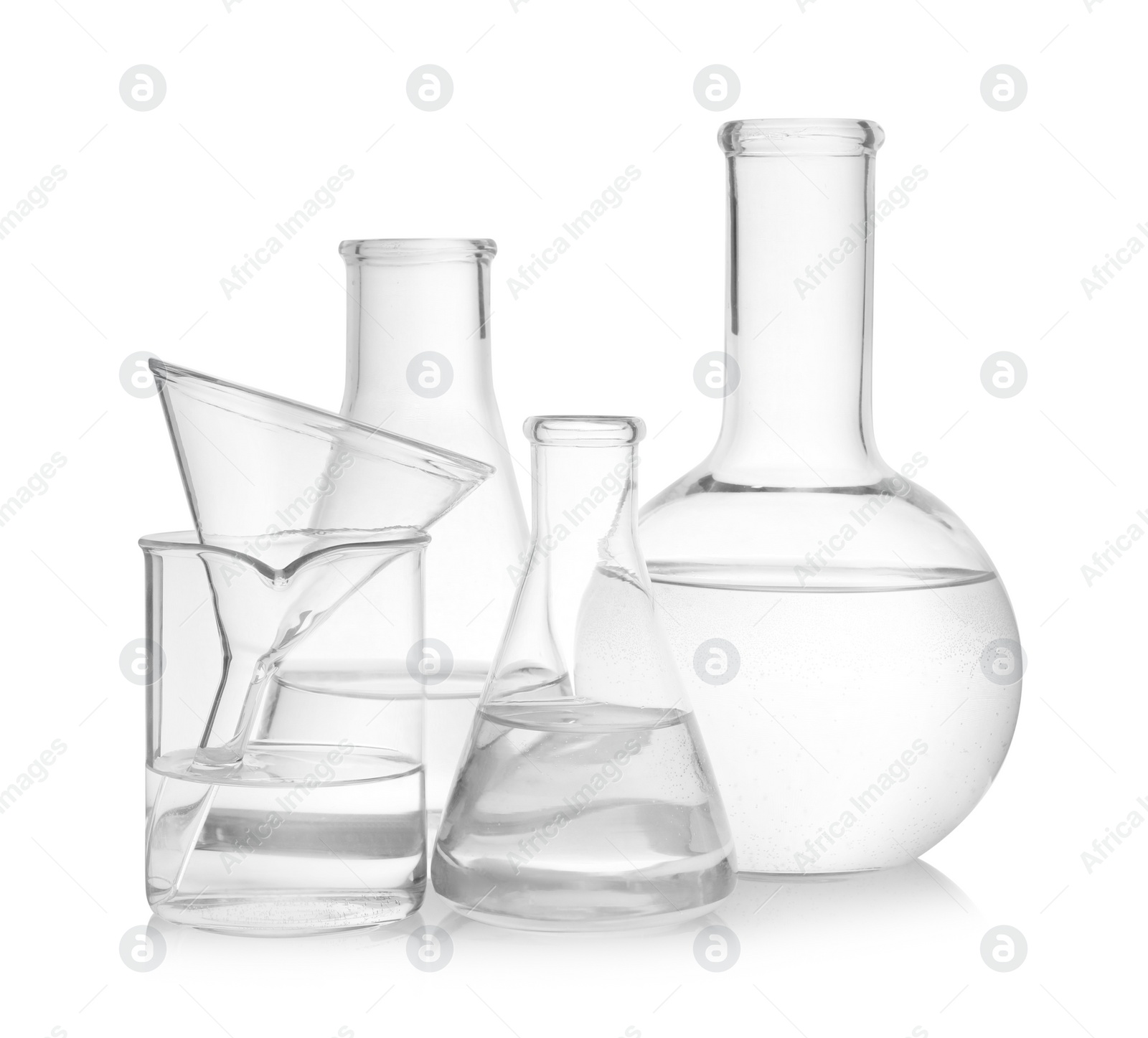 Photo of Laboratory glassware with transparent liquid on white background