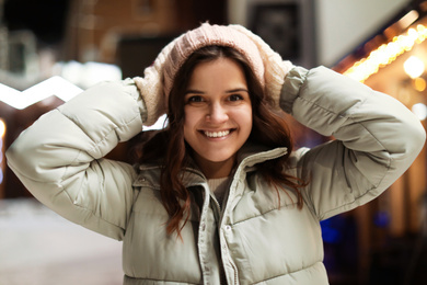 Photo of Beautiful young woman on city street. Winter vacation