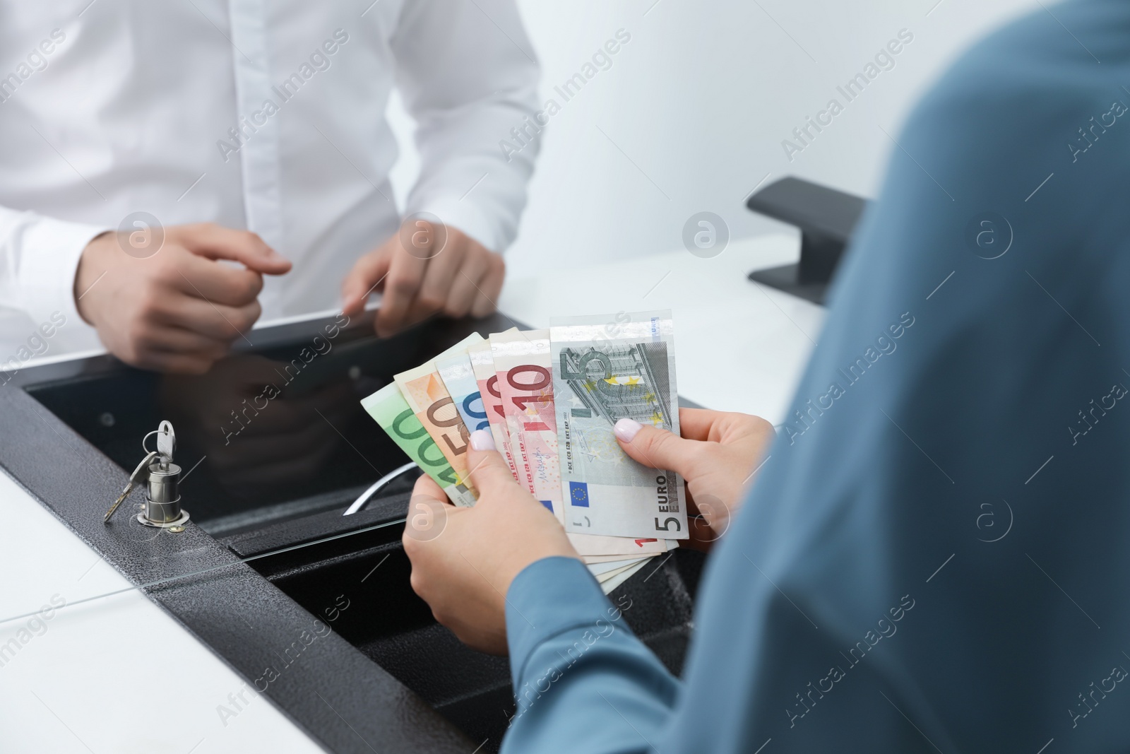 Photo of Woman with money at cash department window, closeup. Currency exchange