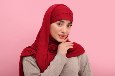 Photo of Portrait of Muslim woman in hijab on pink background