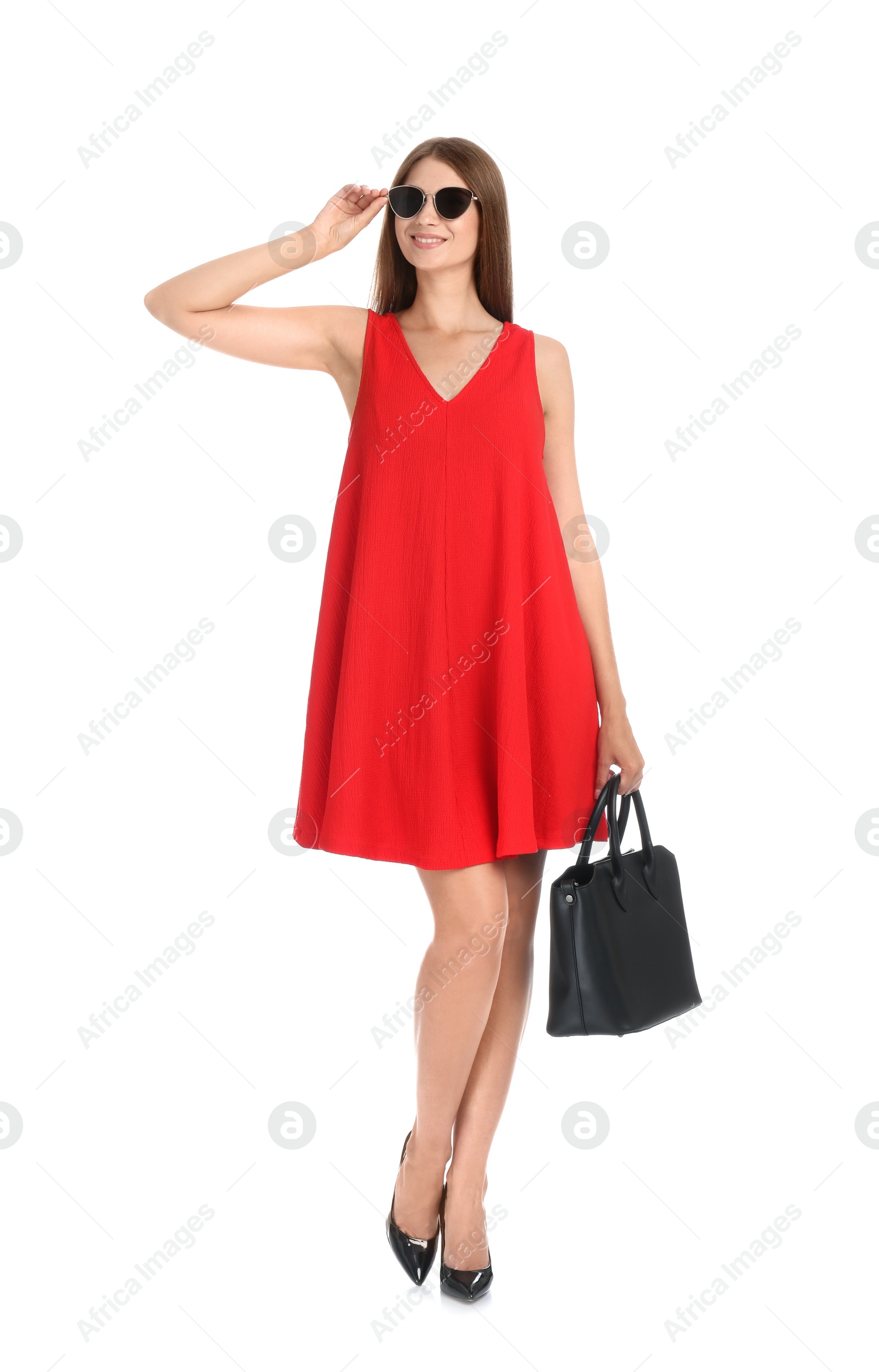 Photo of Young woman wearing stylish red dress with elegant bag on white background