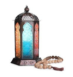 Photo of Decorative Arabic lantern and prayer beads on white background