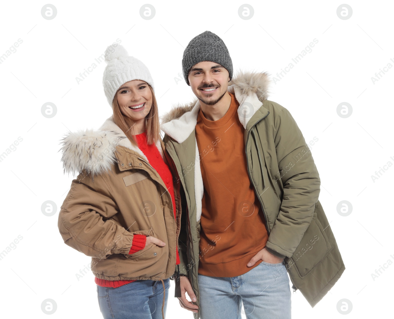 Photo of Young couple wearing warm clothes on white background. Ready for winter vacation