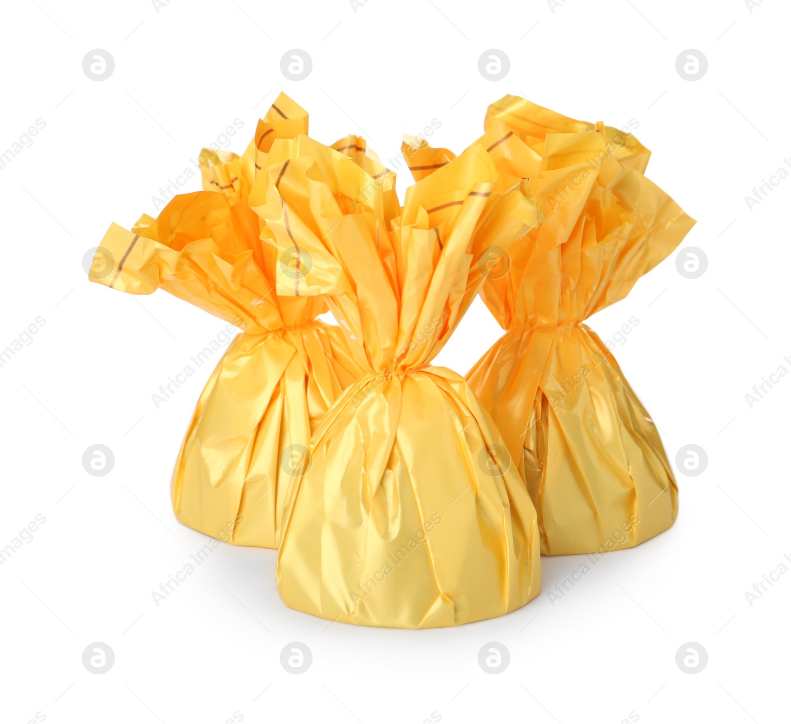 Photo of Delicious candies in yellow wrappers on white background