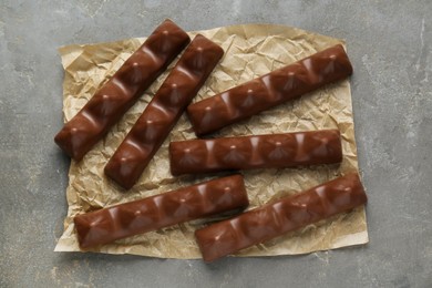 Photo of Tasty chocolate bars on grey table, top view