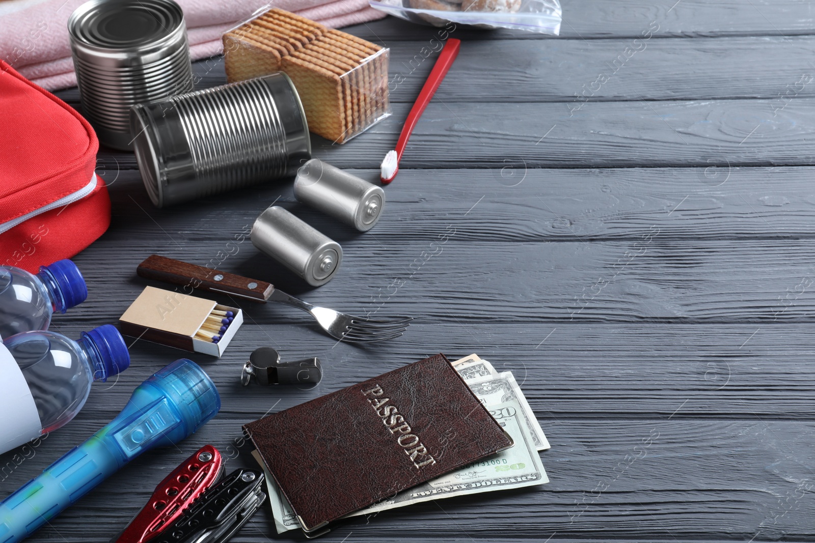 Photo of Earthquake supply kit on black wooden table. Space for text