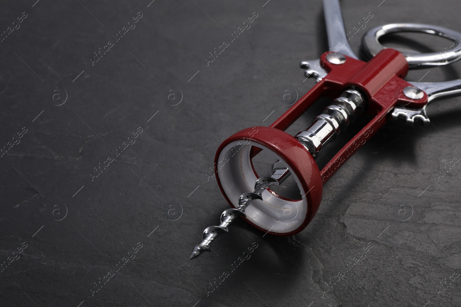 Photo of One wing corkscrew on grey textured table, closeup. Space for text