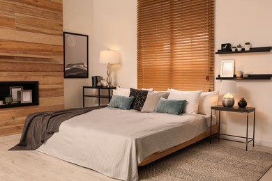 Photo of Stylish room interior with big comfortable bed