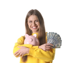 Portrait of happy young woman with money and piggy bank on white background