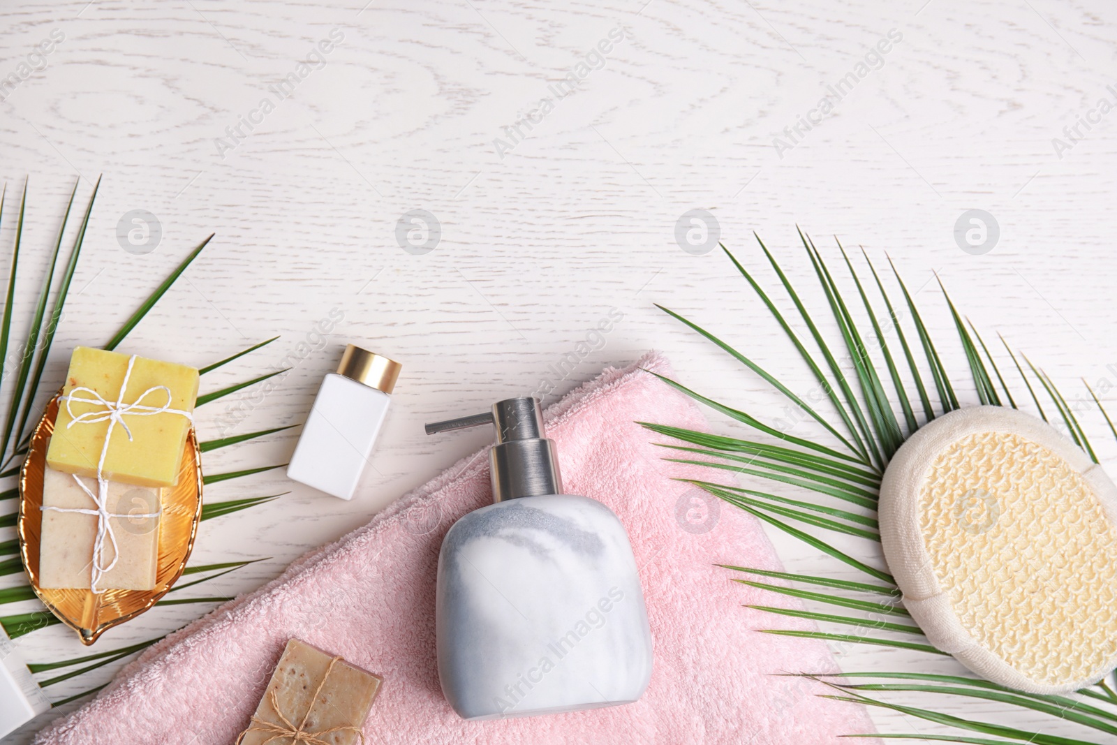 Photo of Flat lay composition with marble soap dispenser on white wooden background. Space for text