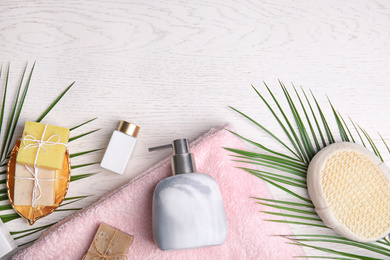 Photo of Flat lay composition with marble soap dispenser on white wooden background. Space for text