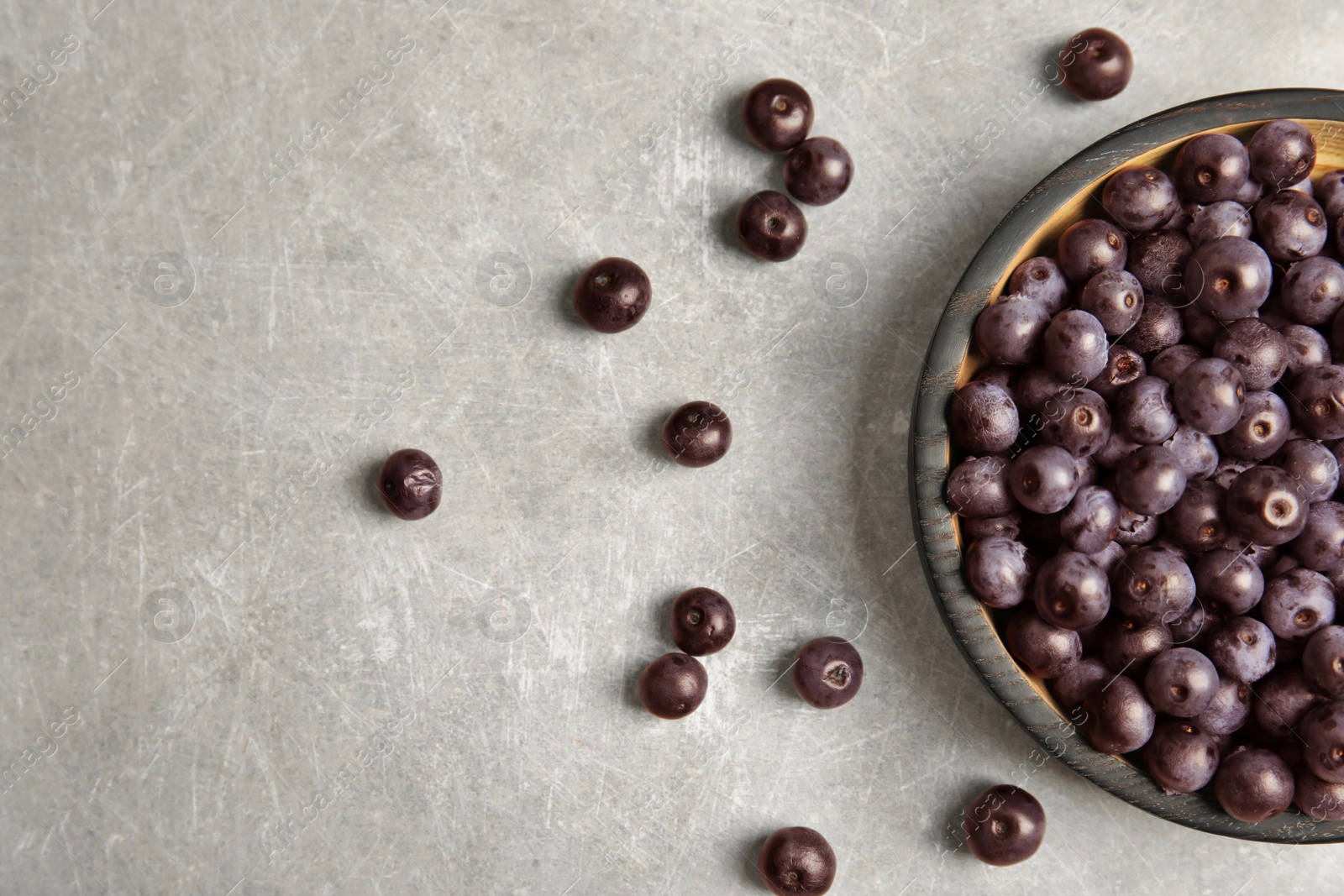 Photo of Plate with fresh acai berries on table, top view