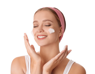 Young woman washing face with cleansing foam on white background. Cosmetic product