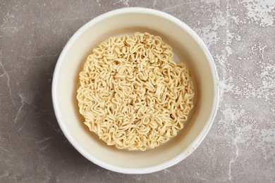 Photo of Cup of instant noodles on table, top view