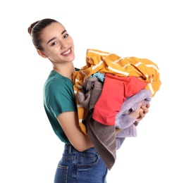 Photo of Happy young woman holding pile of dirty laundry on white background