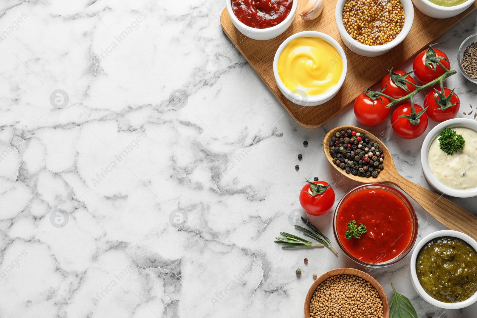 Photo of Flat lay composition with different sauces and space for text on marble background