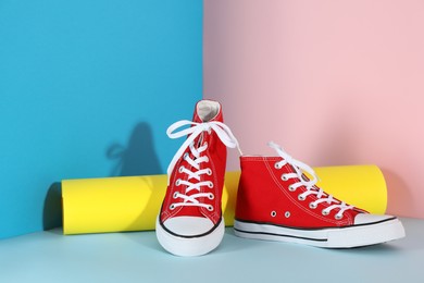 Photo of Pair of stylish sneakers on color background