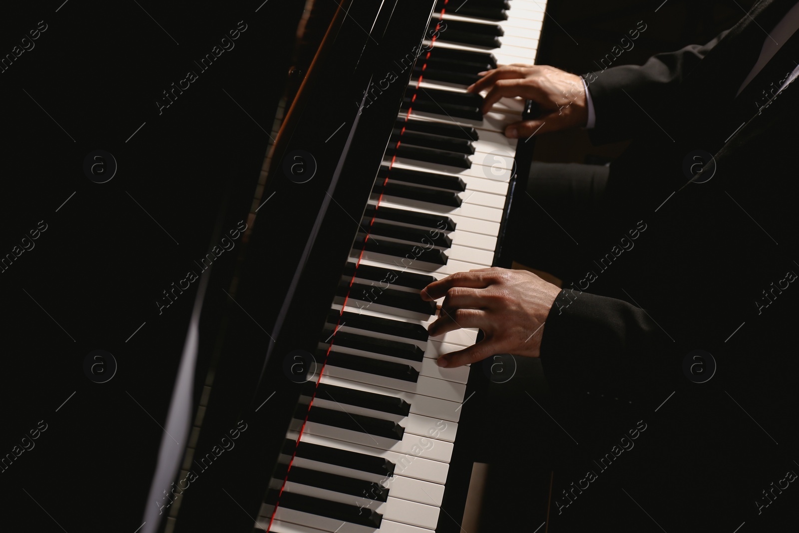 Photo of Man playing piano, above view. Talented musician