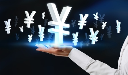 Image of Money exchange concept. Woman with Japanese yen currency symbols on blue background, closeup