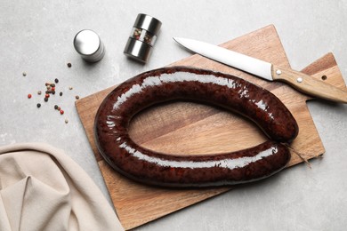 Photo of Tasty blood sausage on grey table, flat lay